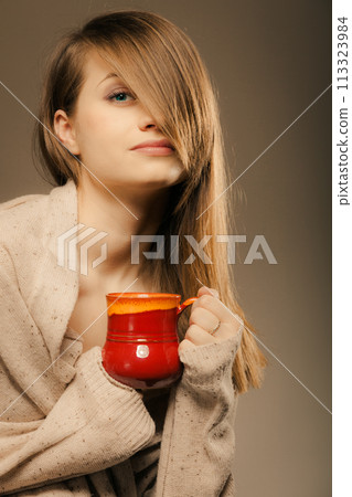 Beverage. Girl holding cup mug of hot drink tea or coffee Beverage. Girl holding cup mug of hot drink tea or coffee 113323984
