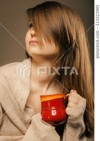 Beverage. Girl holding cup mug of hot drink tea or coffee Beverage. Girl holding cup mug of hot drink tea or coffee 113323985