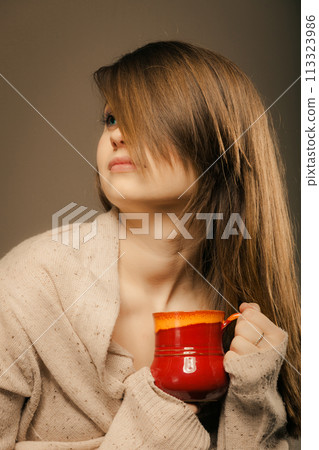 Beverage. Girl holding cup mug of hot drink tea or coffee Beverage. Girl holding cup mug of hot drink tea or coffee 113323986