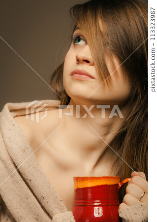 Beverage. Girl holding cup mug of hot drink tea or coffee 113323987