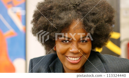 African businesswoman smiling at camera in coworking African businesswoman smiling at camera in coworking 113324440