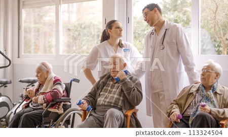 Distracted doctors talking while senior people exercising in geriatric Distracted doctors talking while senior people exercising in geriatric 113324504