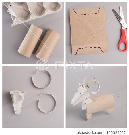 Toilet paper roll crafted into a ram with curled horns on plain surface, promoting recycling and easy kids' craft, animal-themed and educational 113324622