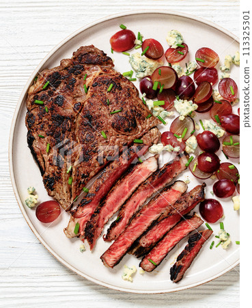 fried beef steak with salad of grape, cheese 113325301