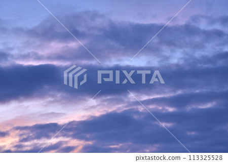 Evening sunset sky. Light blue yellow clouds in the sky. 113325528