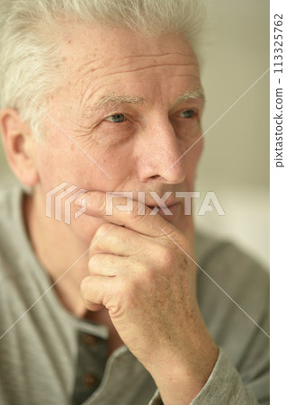 close-up portrait of a senior man thinking about something 113325762
