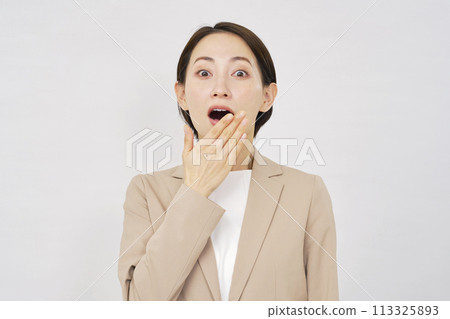 Surprised business woman white background 113325893