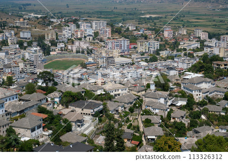 Girokastra is a city in southern Albania, in valley of Drinos River. Administrative center of region and municipality. Mediterranean climate. Cityscape with those famous aligned white facades. 113326312