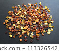 Many amber grains on a black background 113326542