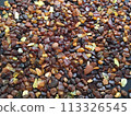 Many amber grains on a black background 113326545