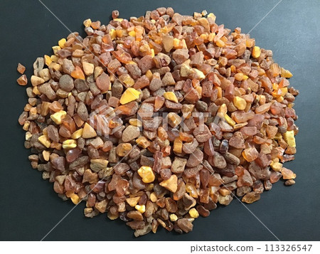 Many amber grains on a black background 113326547