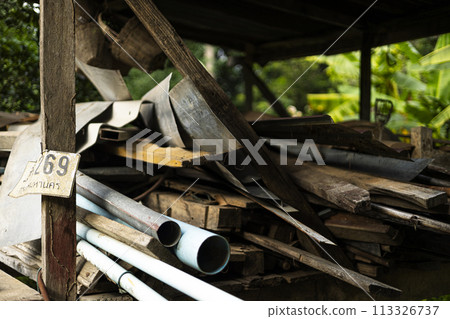 Old wood. Dusty wood chips. Wood for construction a pile of wood lay on the ground. Old wood. Dusty wood chips. Wood for construction a pile of wood lay on the ground. 113326737