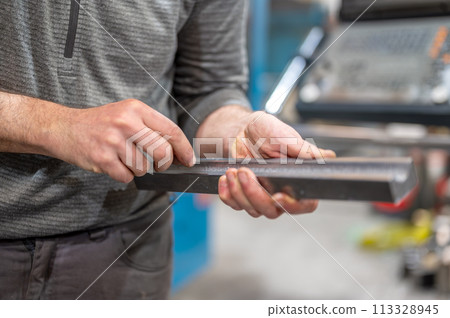 Professional metalworker at the manufacture workshop Professional metalworker at the manufacture workshop 113328945
