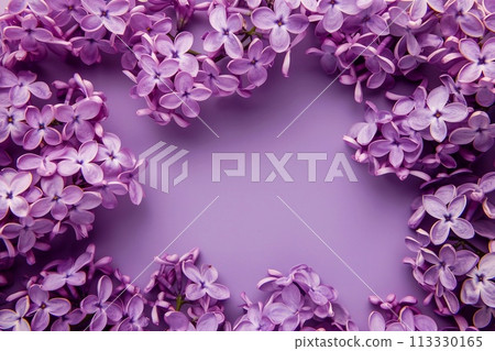 Frame of lilac flowers on a purple background. Top view. 113330165