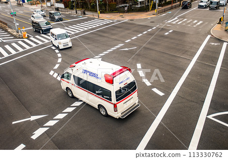 Aerial view of an ambulance passing through an intersection Aerial view of an ambulance passing through an intersection 113330762