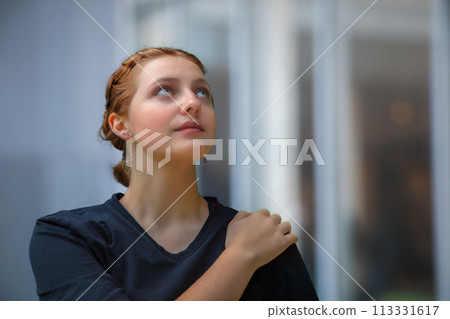 young woman belive in future hand on shoulders looking up young woman belive in future hand on shoulders looking up 113331617