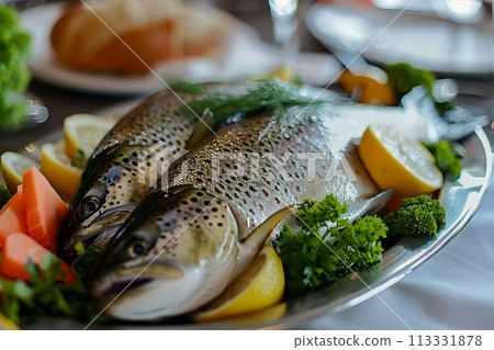 Red trout fish in a dish with seasonings and herbs on the table, healthy sea fish 113331878