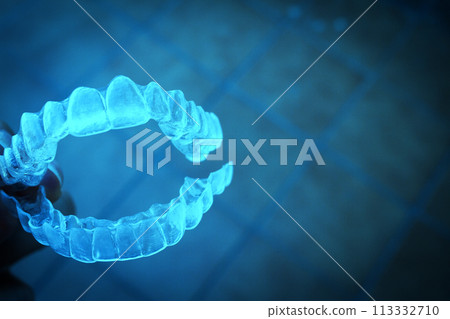 Invisible teeth aligner on light background Invisible teeth aligner on light background 113332710