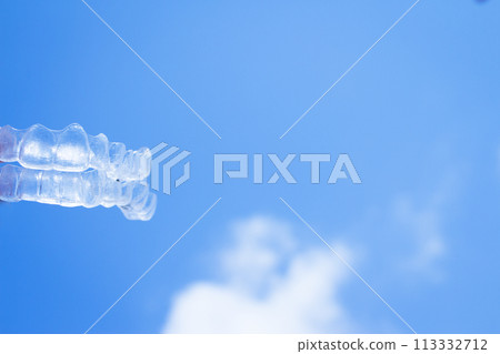 Invisible teeth aligner on light background Invisible teeth aligner on light background 113332712