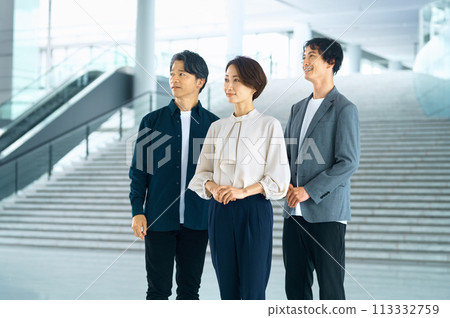 Smiling business team lined up in the office 113332759