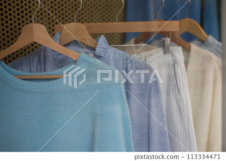 closeup of boho style clothes on hanger in a fashion store showroom closeup of boho style clothes on hanger in a fashion store showroom 113334471