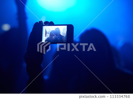 Nightclub, festival and audience with selfie or lights for music, party and rave concert with silhouette and memory. Disco, psychedelic event and performance with entertainment, crowd and smartphone Nightclub, festival and audience with selfie or lights for music, party and rave concert with silhouette and memory. Disco, psychedelic event and performance with entertainment, crowd and smartphone 113334768
