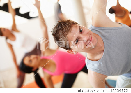 Portrait, smile and stretching, man in yoga class for fitness, commitment and body wellness. Pilates, men and women in gym together for holistic health, mindfulness and happy person at exercise club. 113334772