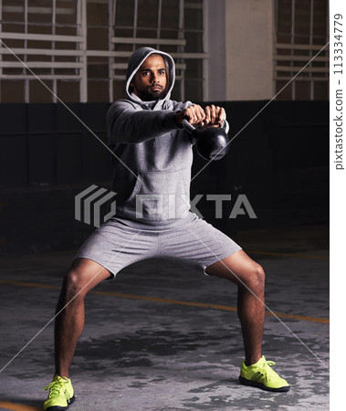 Man, fitness and workout with kettlebell for training, muscle exercise and endurance in parking lot. Bodybuilder, serious face and equipment with weight for balance, strength and healthy body Man, fitness and workout with kettlebell for training, muscle exercise and endurance in parking lot. Bodybuilder, serious face and equipment with weight for balance, strength and healthy body 113334779