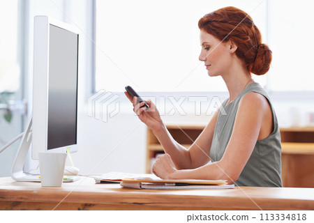 Business woman, phone and reading or typing at office desk for social media, communication or network. Professional worker, employee or person in public relations with mobile for chat and check email 113334818