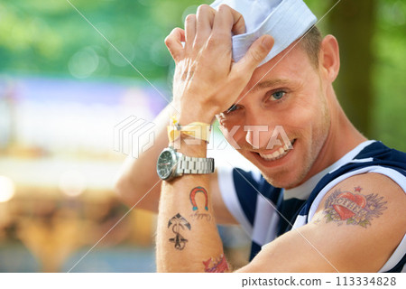 Portrait, music festival and man with a smile, tattoo and sailor outfit with confidence and happiness. Face, person and guy in a costumer and Halloween with concert and sunshine with fun and cheerful 113334828