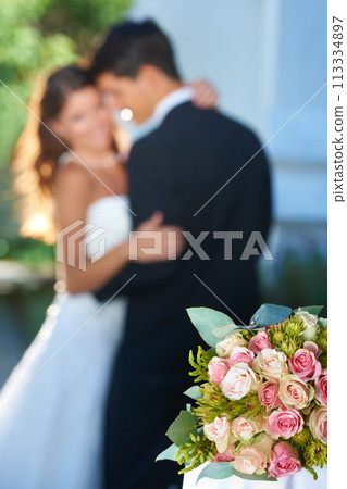 Flower bouquet, happy couple and blurred embrace at wedding with love, smile and commitment at reception. Roses, woman and man hugging at marriage celebration event, partnership and future together. Flower bouquet, happy couple and blurred embrace at wedding with love, smile and commitment at reception. Roses, woman and man hugging at marriage celebration event, partnership and future together. 113334897