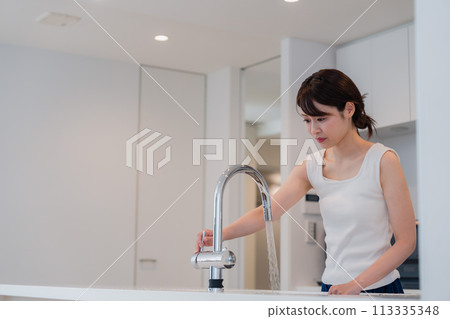 Young woman washing her face at home Young woman washing her face at home 113335348