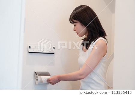 Young woman pulling toilet paper Young woman pulling toilet paper 113335413