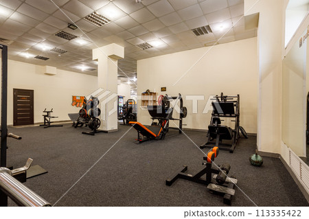 Exercise equipment in an empty gym 113335422
