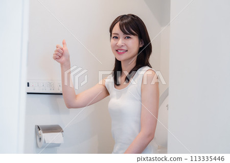 Young woman making an OK sign in the toilet 113335446