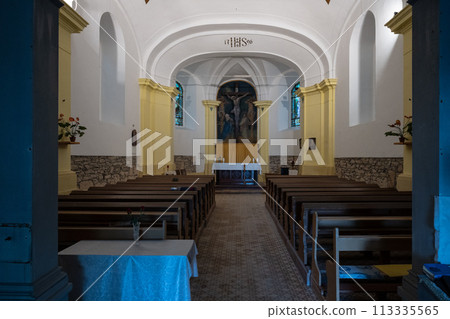 A serene view inside Chapel of the Holy Cross showcasing the simple elegant architecture, with rows of wooden pews leading to the altar adorned with religious artwork. Jiretin pod Jedlovou, Czechia A serene view inside Chapel of the Holy Cross showcasing the simple elegant architecture, with rows of wooden pews leading to the altar adorned with religious artwork. Jiretin pod Jedlovou, Czechia 113335565