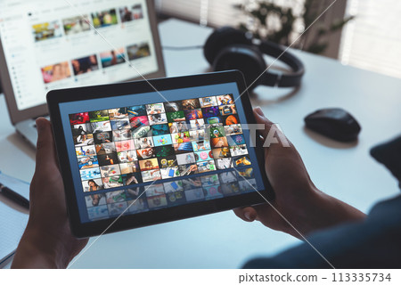 Man watching media on digital tablet 113335734