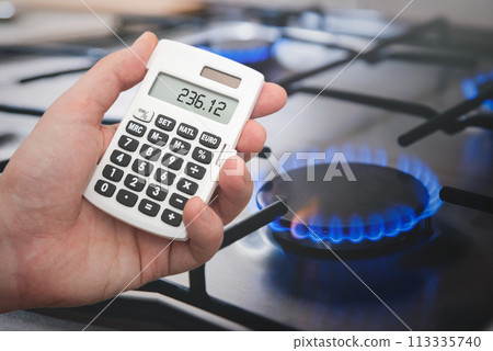 Man counts gas bills on a calculator Man counts gas bills on a calculator 113335740
