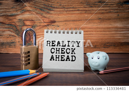 Reality Check Ahead. Cardboard notepad on wooden texture table Reality Check Ahead. Cardboard notepad on wooden texture table 113336481