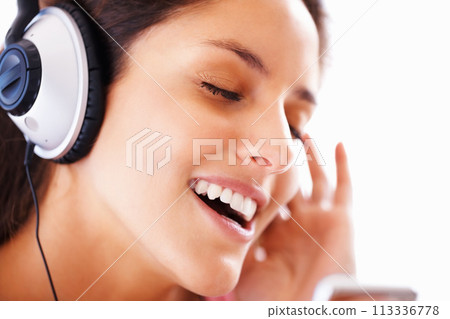 Music headphones, singing and woman face listening to playlist track, audio podcast or wellness sound. Freedom, eyes closed and closeup girl, student or singer streaming media, song or radio app Music headphones, singing and woman face listening to playlist track, audio podcast or wellness sound. Freedom, eyes closed and closeup girl, student or singer streaming media, song or radio app 113336778