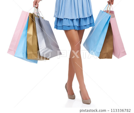 Studio, closeup and legs with shopping bags, sales and consumerism or luxury spending. Woman, white background and retail customer with discount, choice and happiness of service, heels or shoes Studio, closeup and legs with shopping bags, sales and consumerism or luxury spending. Woman, white background and retail customer with discount, choice and happiness of service, heels or shoes 113336782
