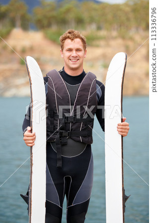 Lake, ski and portrait of man with wakeboard for surfing, exercise and recreation hobby outdoors. Fitness, extreme sports and happy person with board for water skiing for freedom, adventure and fun Lake, ski and portrait of man with wakeboard for surfing, exercise and recreation hobby outdoors. Fitness, extreme sports and happy person with board for water skiing for freedom, adventure and fun 113336796