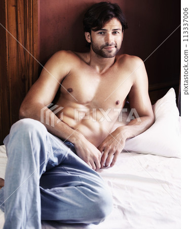 Portrait, sexy and man relax on bed with muscles, six pack and strong shirtless body at home. Muscular, handsome and happy guy rest in bedroom with bare abs, topless desire and good mood in morning Portrait, sexy and man relax on bed with muscles, six pack and strong shirtless body at home. Muscular, handsome and happy guy rest in bedroom with bare abs, topless desire and good mood in morning 113337006
