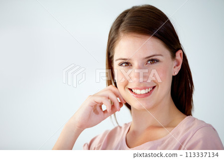 Portrait, face of woman and smile in studio to relax for break, rest and confident personality on white background. Happy, young and beautiful model with good mood, pride and optimism at mockup space 113337134