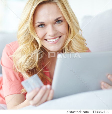 Finding everything she needs online. Portrait of a beautiful young woman using her digital tablet and credit card to shop online. 113337199