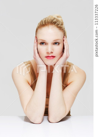 Beauty, makeup and young woman in a studio with self care, cosmetic and face routine. Beautiful, thinking and female person from Australia with facial cosmetology isolated by gray background. 113337226