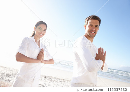 Portrait, prayer pose and couple at beach for yoga retreat with smile, peace and relax in mindfulness. Zen, man and woman with meditate for holistic health, spiritual wellness and namaste at ocean Portrait, prayer pose and couple at beach for yoga retreat with smile, peace and relax in mindfulness. Zen, man and woman with meditate for holistic health, spiritual wellness and namaste at ocean 113337280