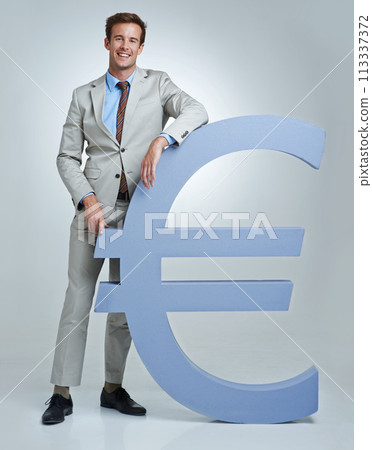 Portrait, Euro currency symbol and man with business, finance and investor on a grey studio background. Person, employee and model with accountant, trader and stock market with economy, emoji or icon Portrait, Euro currency symbol and man with business, finance and investor on a grey studio background. Person, employee and model with accountant, trader and stock market with economy, emoji or icon 113337372