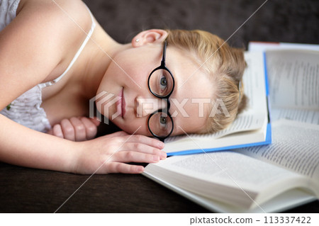 Portrait, learning and a child reading a book for knowledge, studying or to relax on the floor. Library, young and a girl, kid or a student at school with a novel, story or getting ready for an exam Portrait, learning and a child reading a book for knowledge, studying or to relax on the floor. Library, young and a girl, kid or a student at school with a novel, story or getting ready for an exam 113337422
