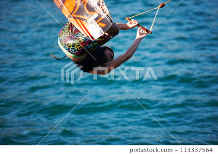 Man, wakeboarding and ocean with jump, sport and fitness with speed on vacation in summer sunshine. Person, athlete and ski with rope for safety on lake, sea or river with training, exercise or waves 113337564